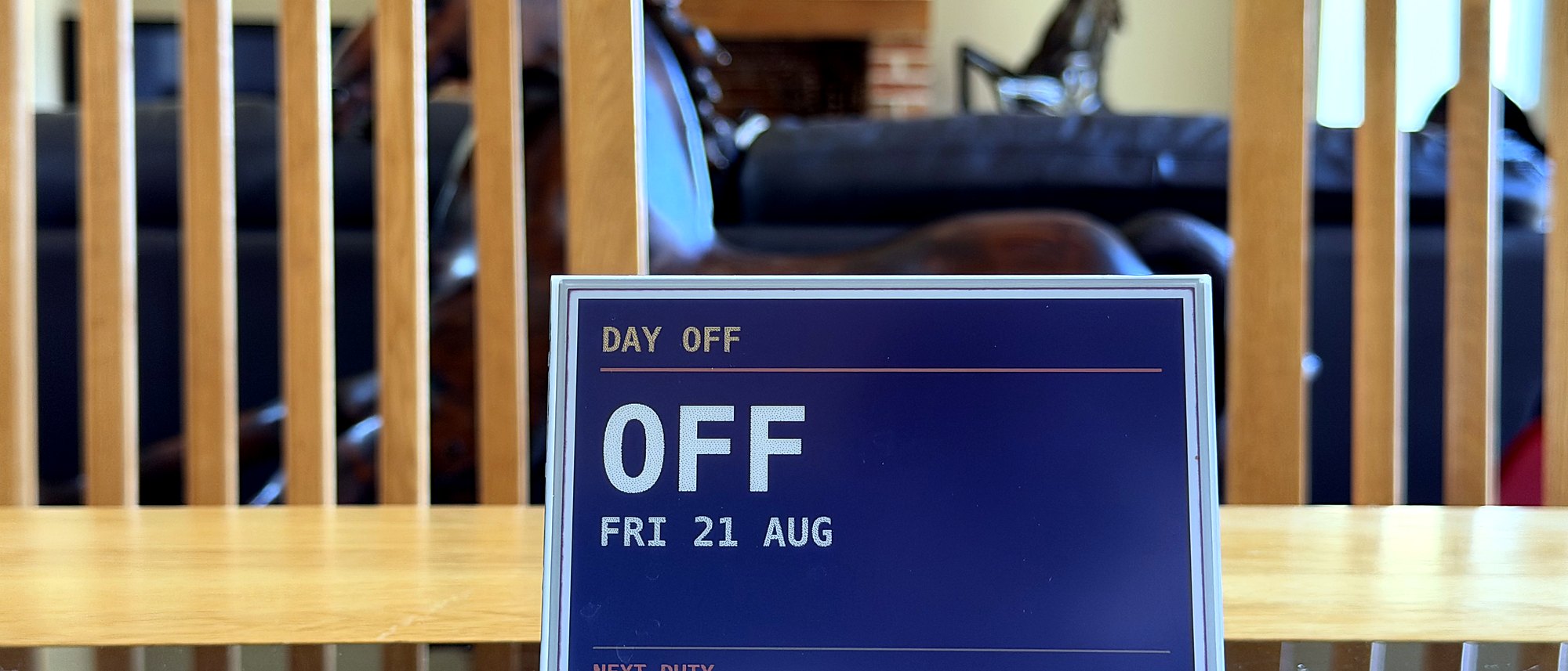 An Ident display on a dining table in a family living room, showing the day off and the next duty