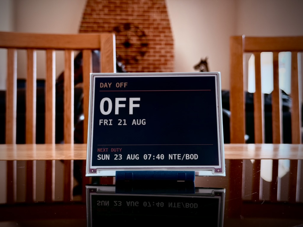 A 5.7 inch Ident on a dining table showing DAY OFF, FRI 21 AUG and the next duty on Sunday